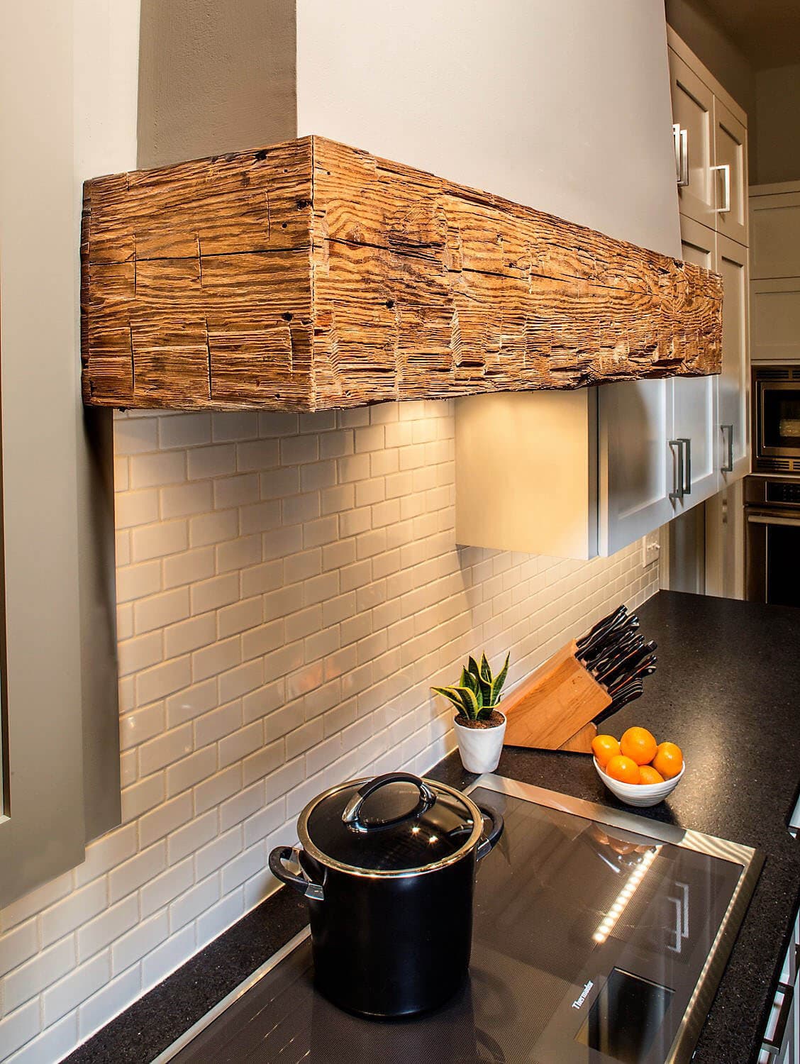 Reclaimed wood for custom crafted kitchen stove hood.