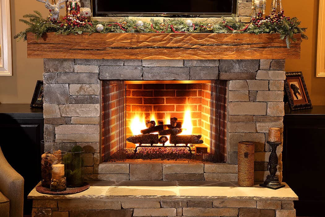 Reclaimed hardwood mantel with rippled texture in Greenville South Carolina home.