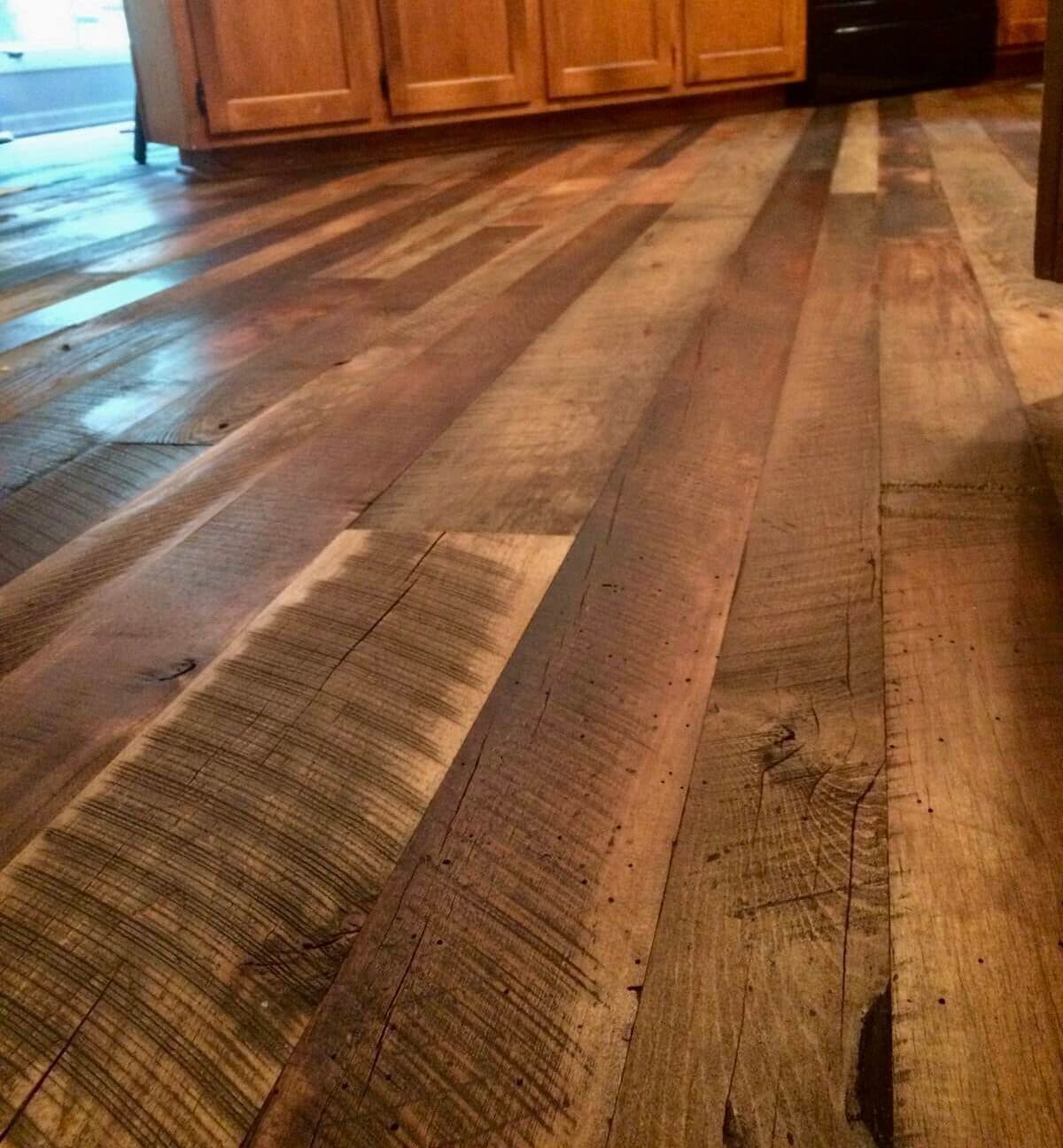 Rustic hardwood floor in kitchen utilizes multiple reclaimed wood species.