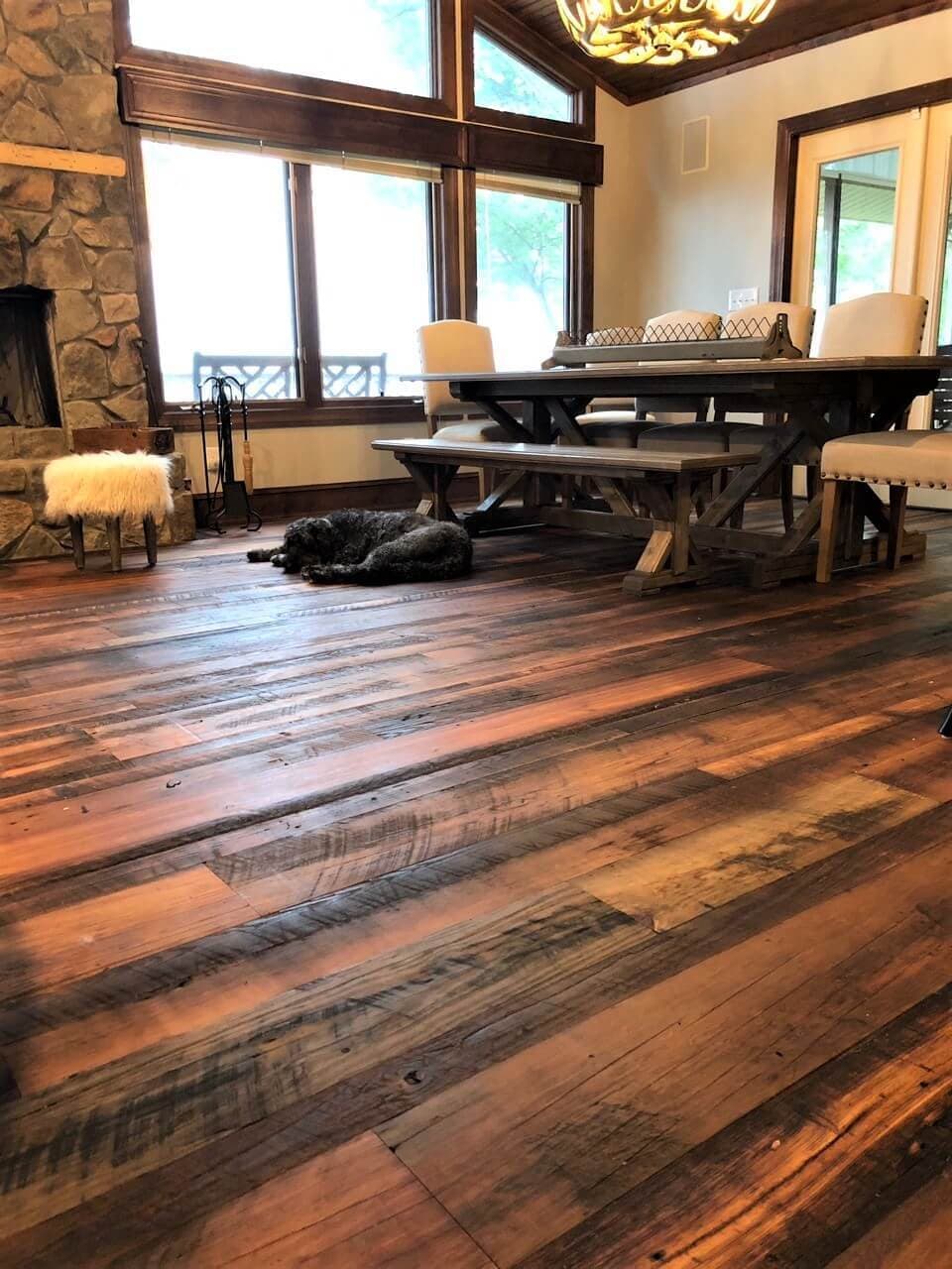 Rustic reclaimed heart pine flooring with natural woca oil finish in great room.