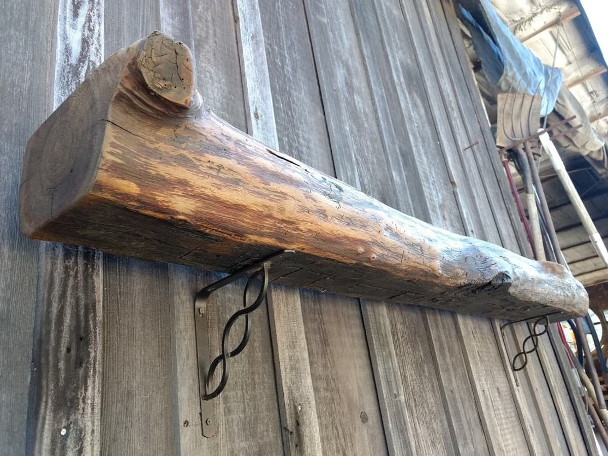 Rustic live edge mantel with knobby unfinished features.