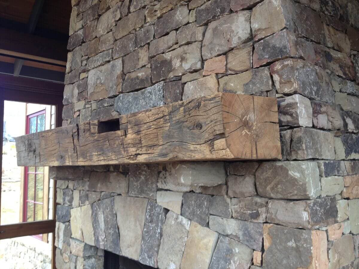 Rustic hand hewn mantel on outdoor porch in black mountain nc