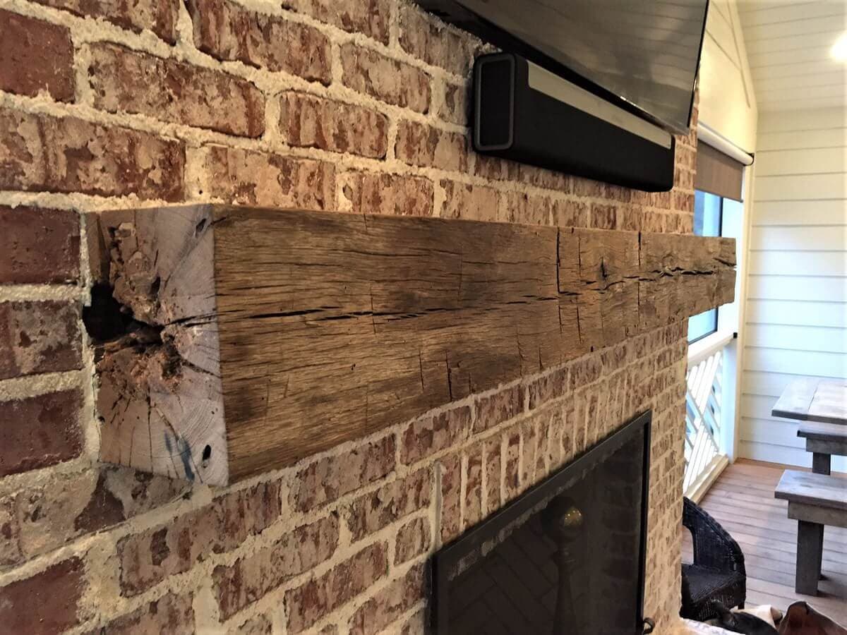Hand Hewn rustic wood mantel over brick fireplace in Greenville, SC