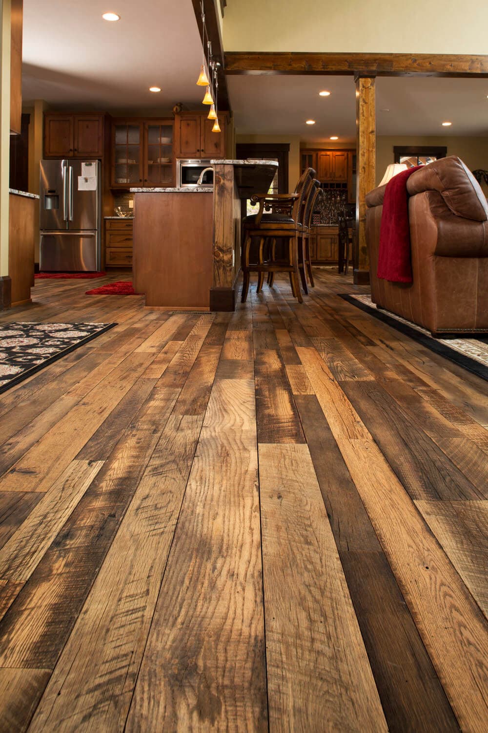 Rustic reclaimed hardwood flooring in kitchen.