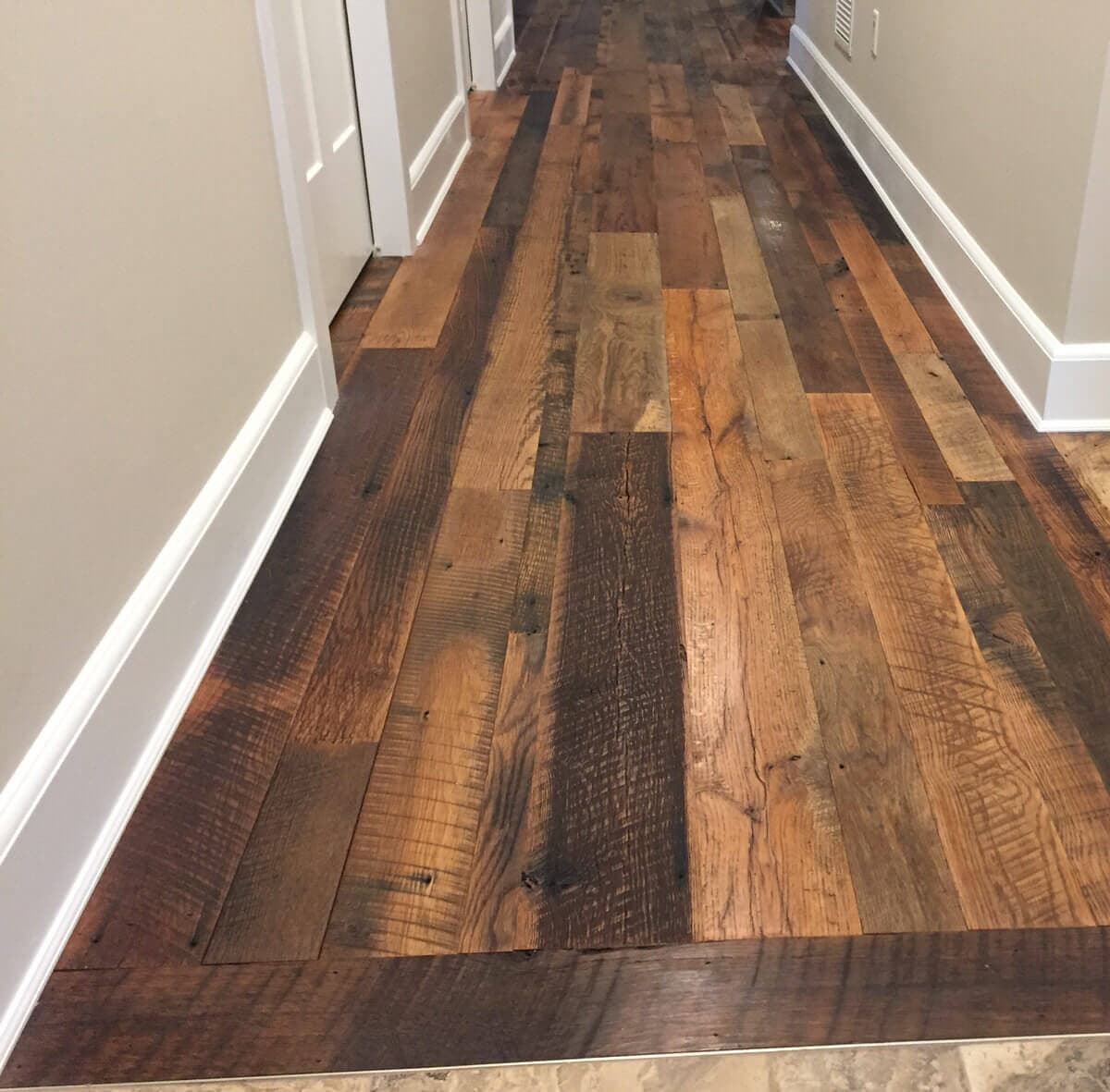 Rustic reclaimed oak flooring in hallway.