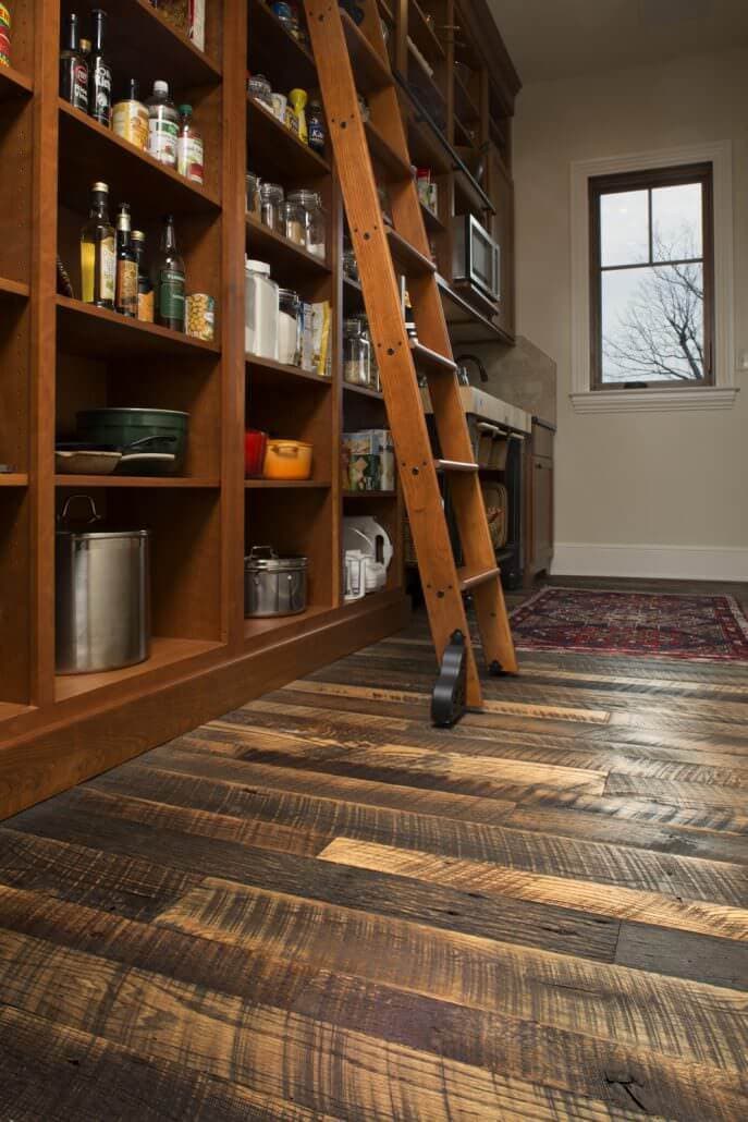 Rustic reclaimed oak flooring in kitchen pantry.