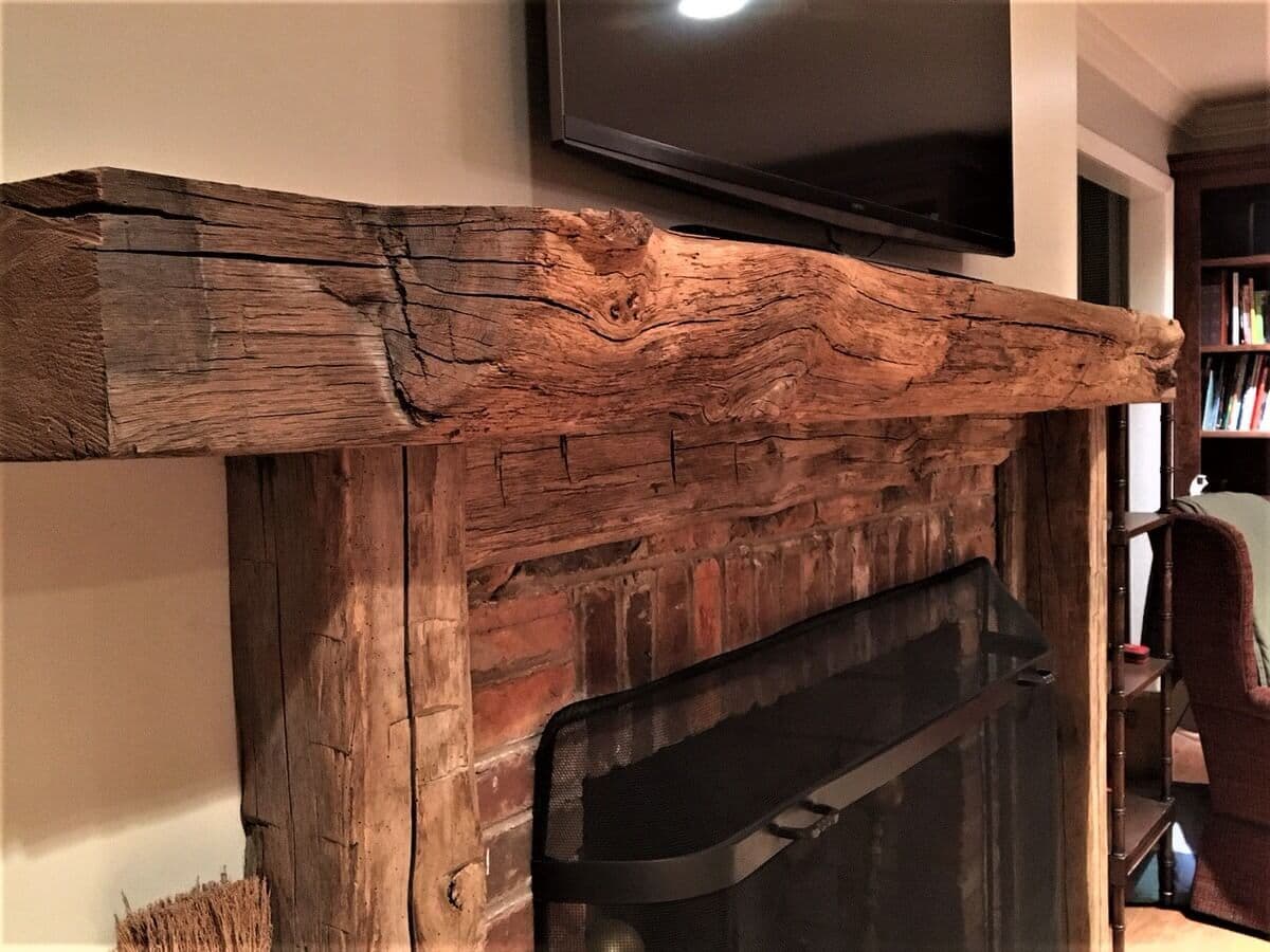 live edge rustic wood mantel with hand hewn support timbers