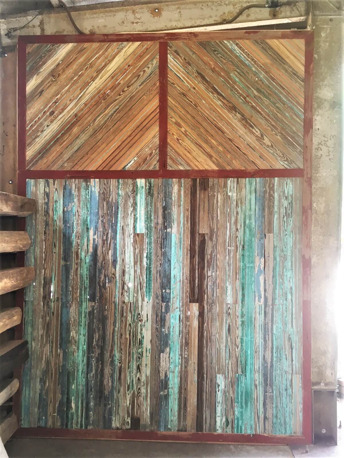 Reclaimed wood accent wall with weathered look and beautiful colors.