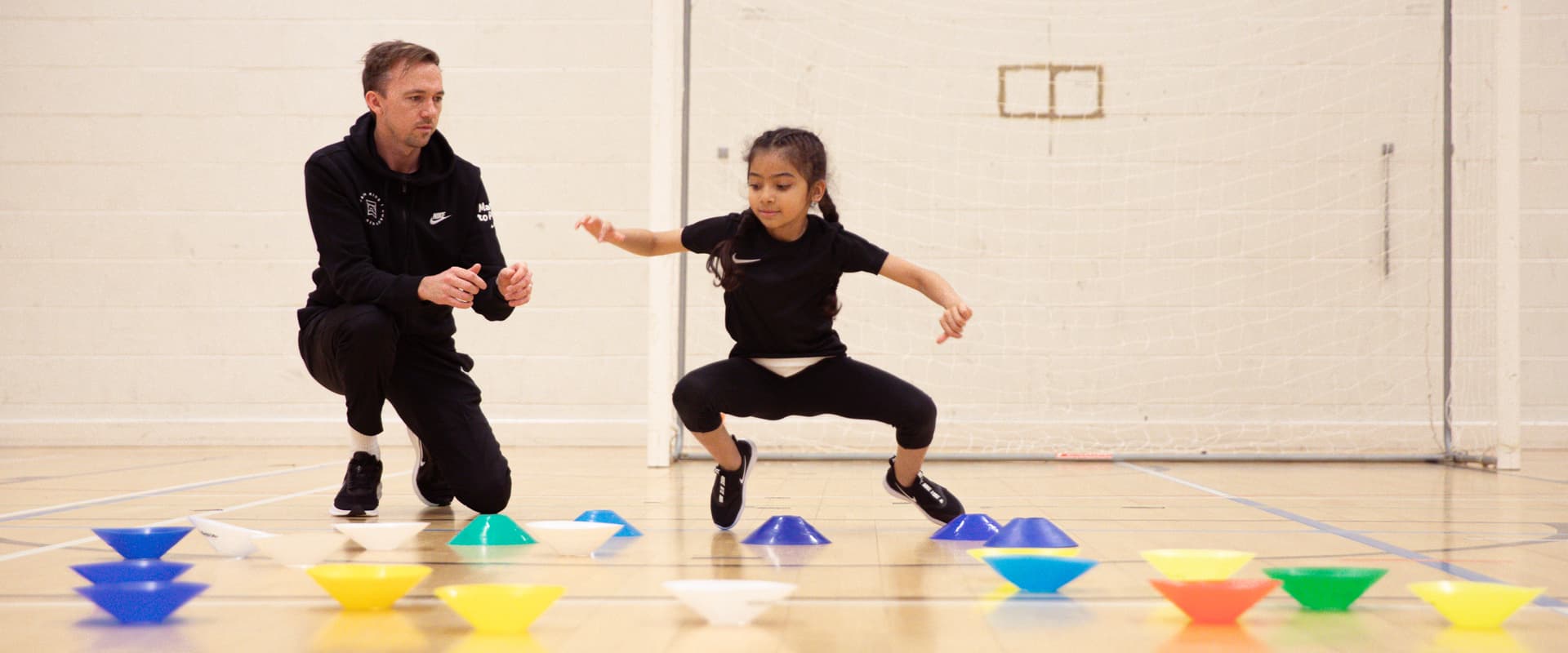 Girl going between cones