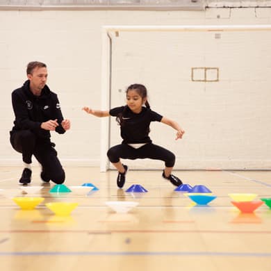 Girl going between cones