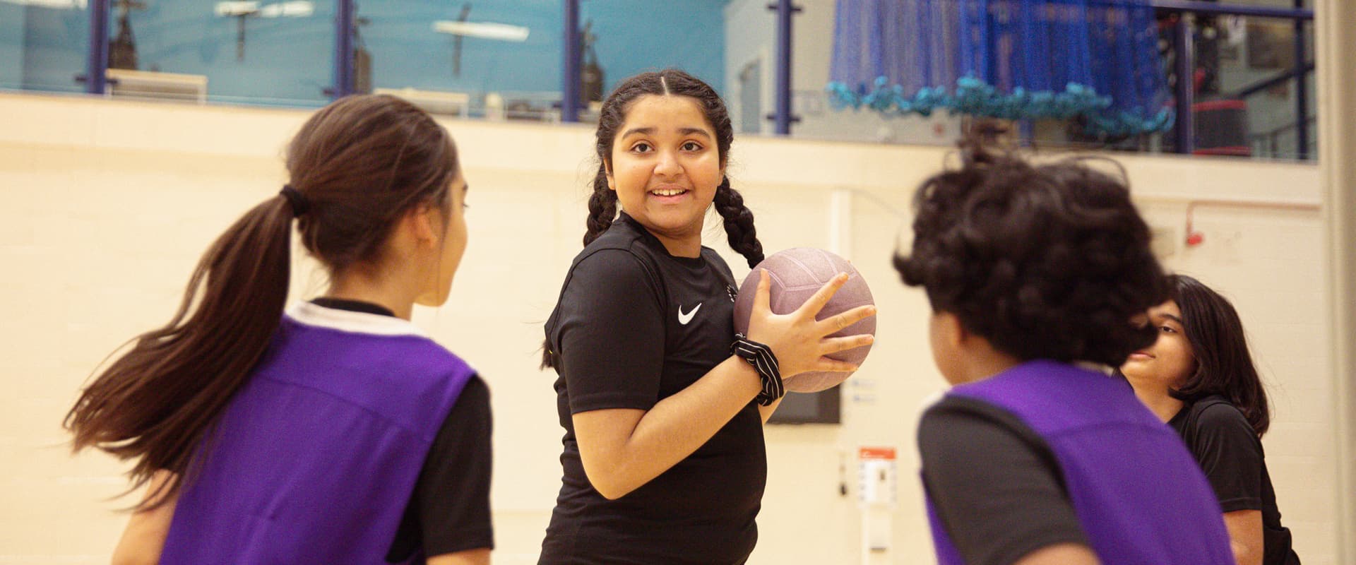 Girl with ball looking into camera