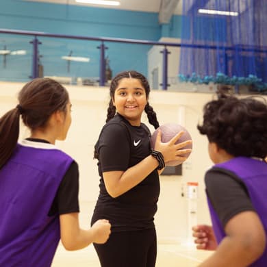 Girl with ball looking into camera