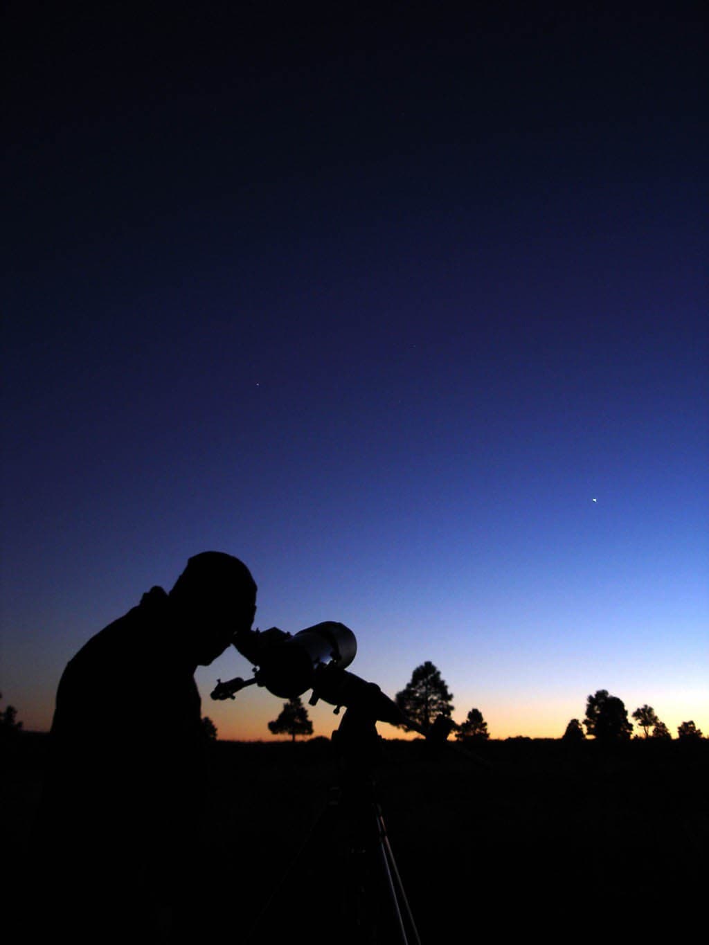 Guy looking into telescope