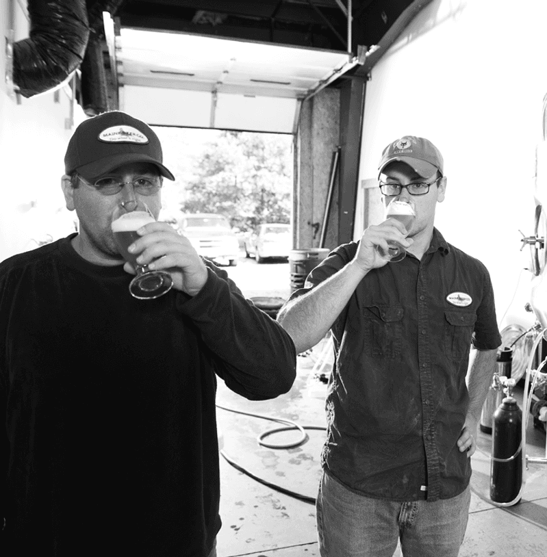 Co-founders David and Daniel Kleban drinking their beer in the original facility in Portland.