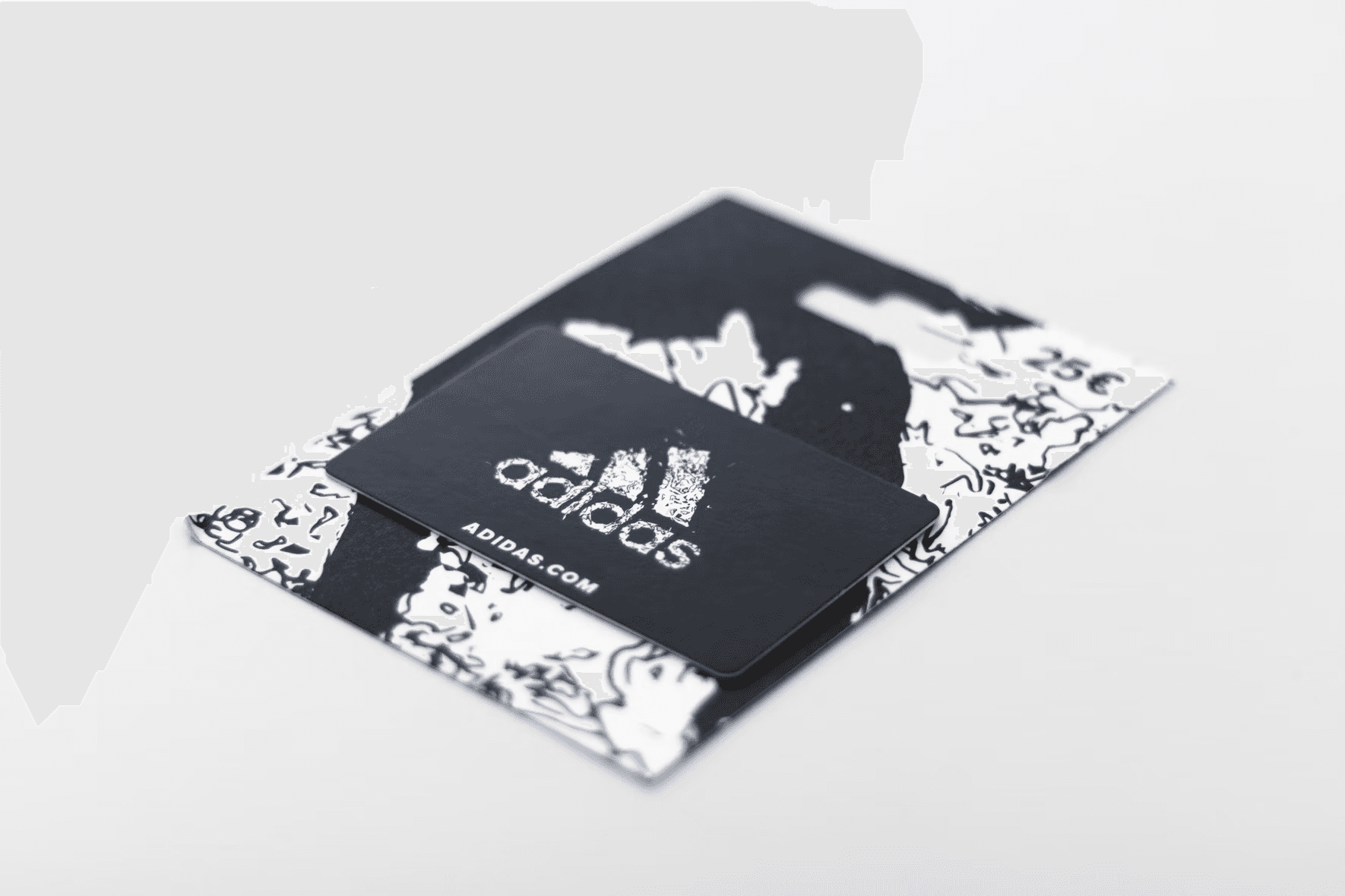 An Adidas gift card is laying against a white background.