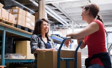 A manager and employee are working on their communication skills while talking over a production shipment.