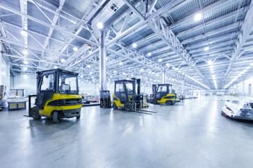 empty warehouse with three unmanned forklifts