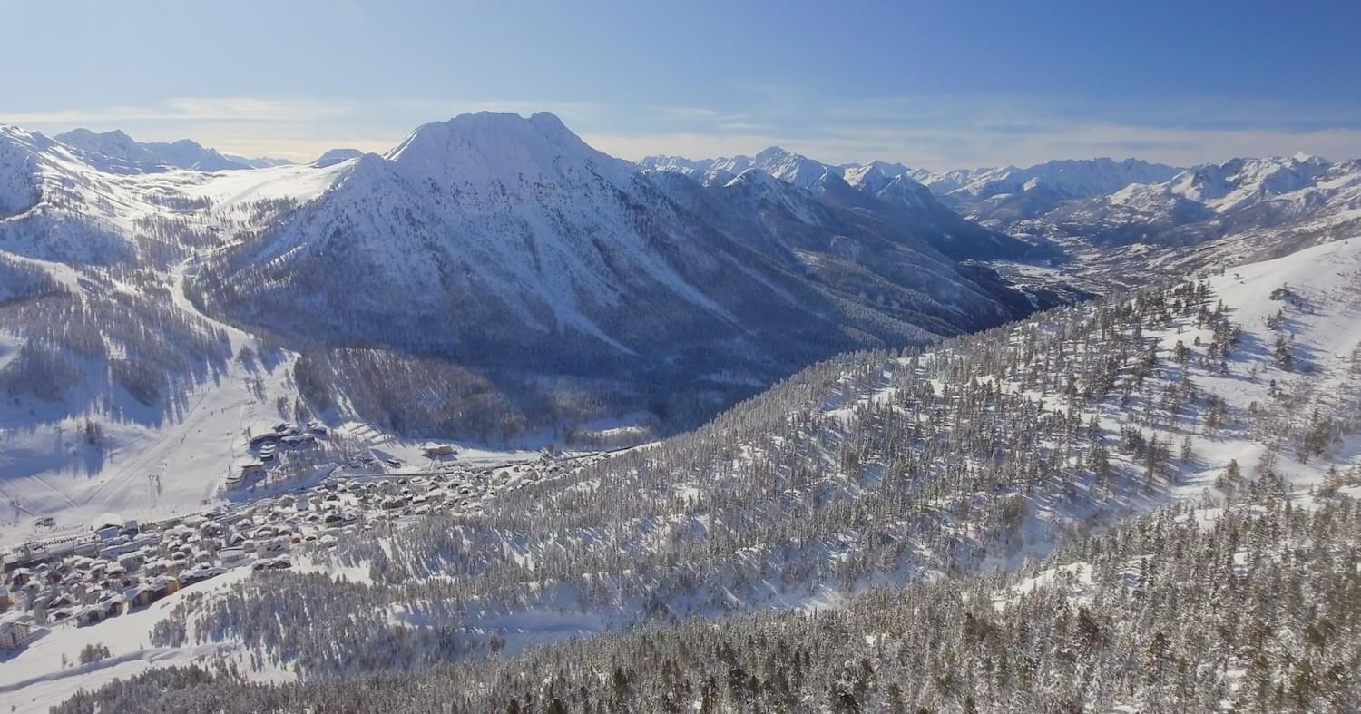 An aerial photo of the village of Montgenevre in winter, taken from a drone