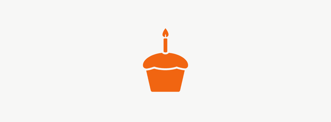 Orange cupcake with one candle