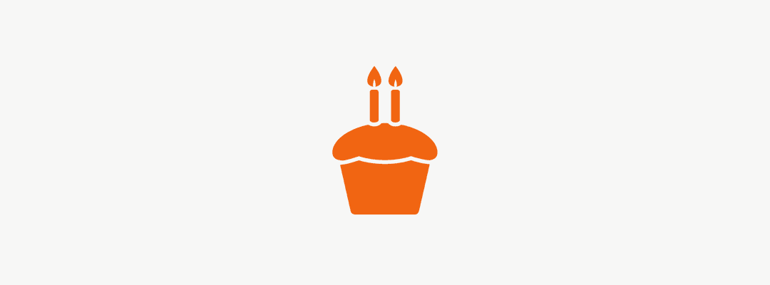 Orange cupcake with two candles