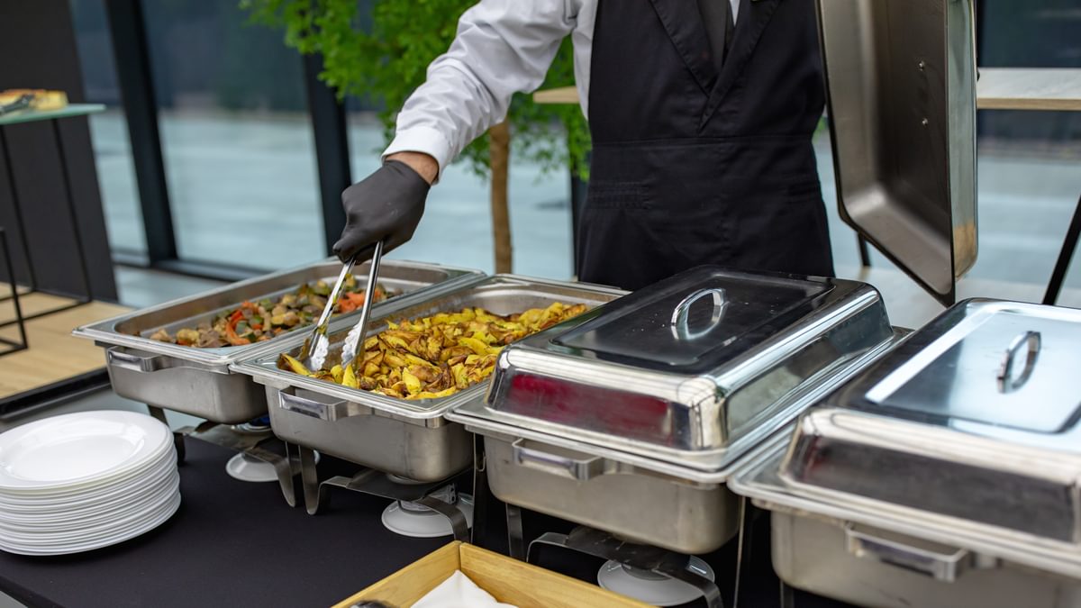 catering buffet with a dedicated service personnel
