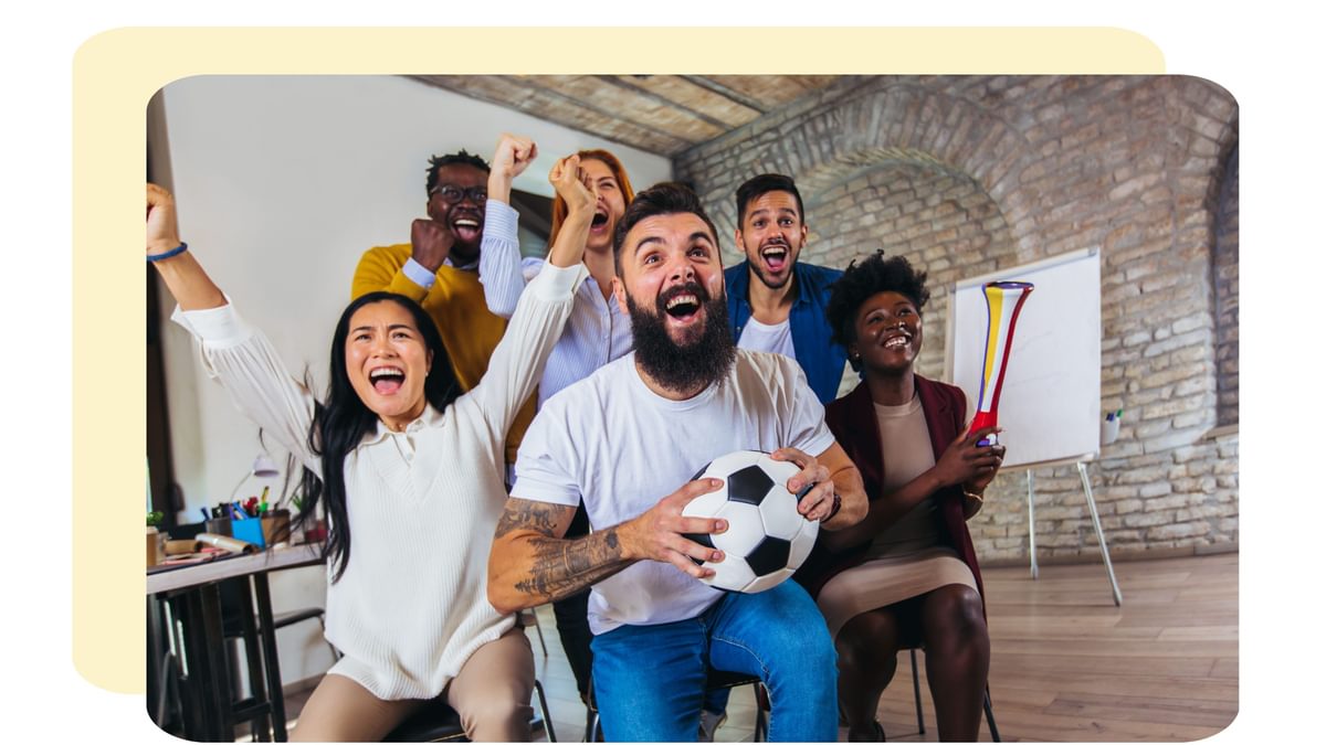 An image of people watching football in the office