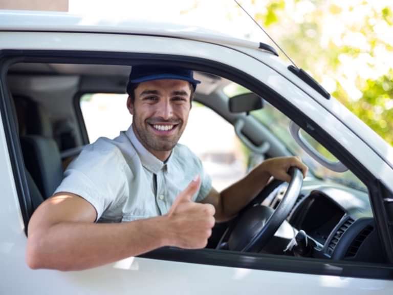 A boy in a van delivering catering