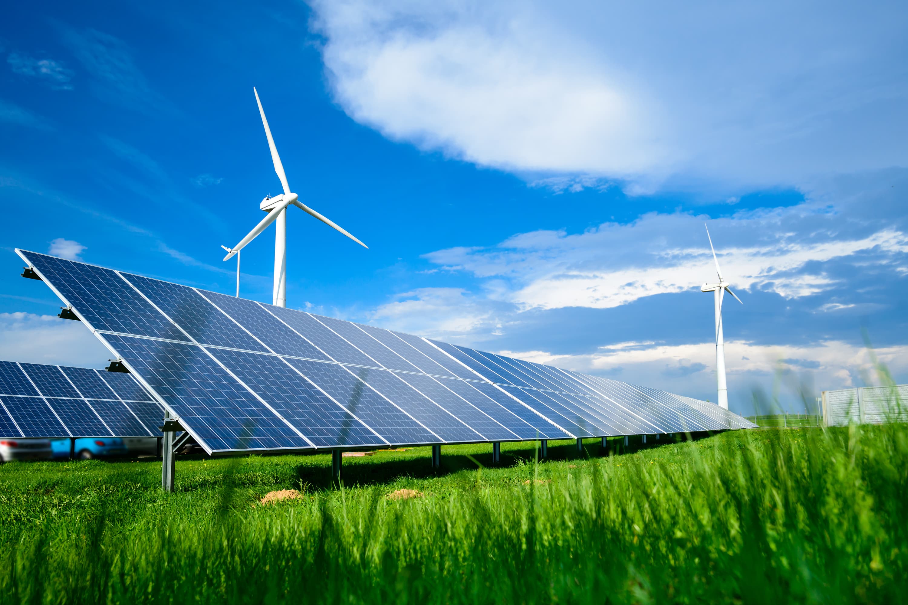 Photovoltaic panels with wind turbines