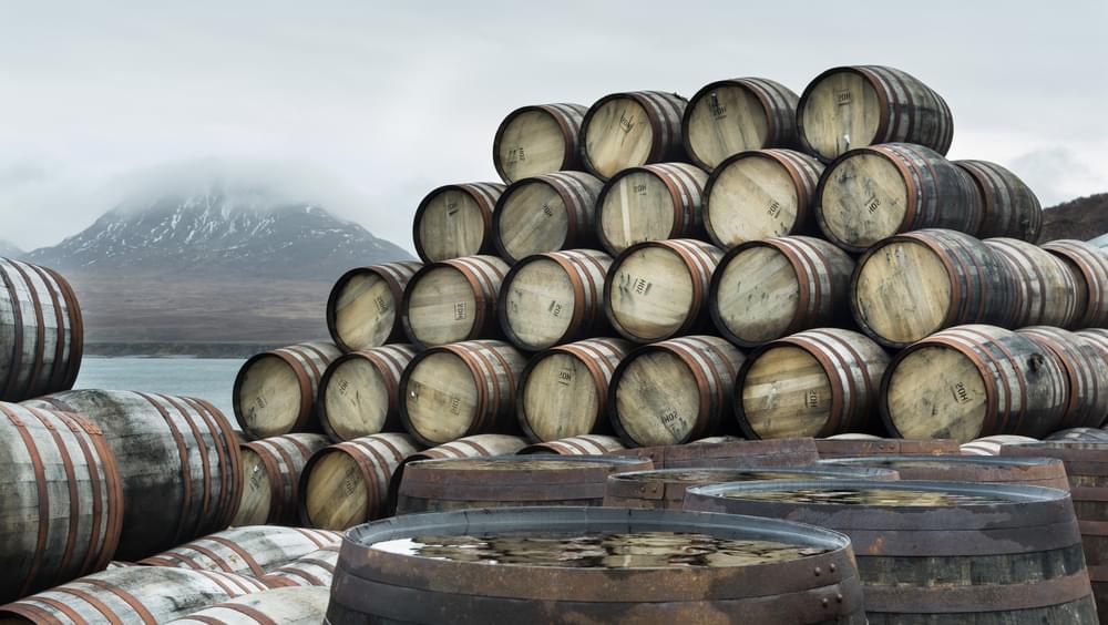 Whisky casks stockpiled outside Bunnahabhain distillery waiting to be filled