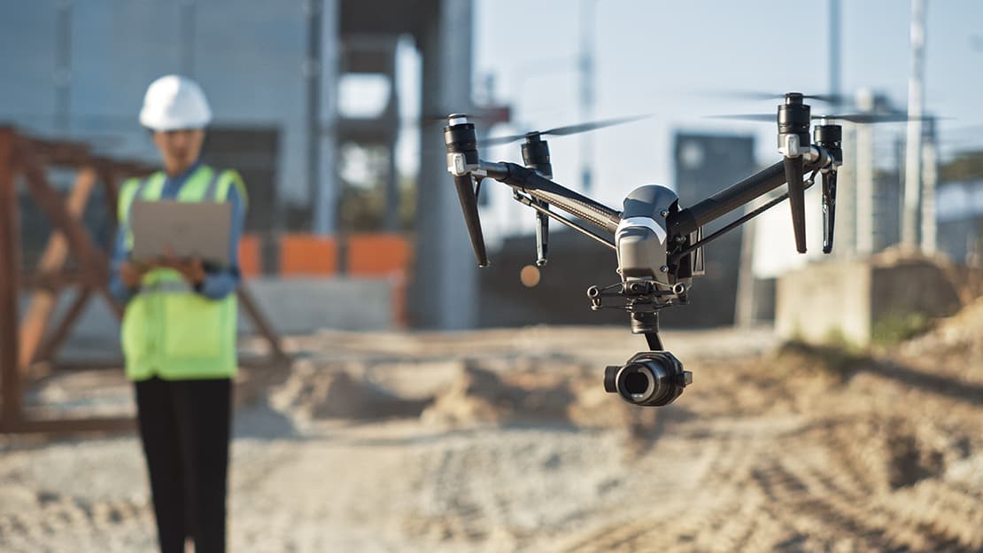 Construction worker flying drone