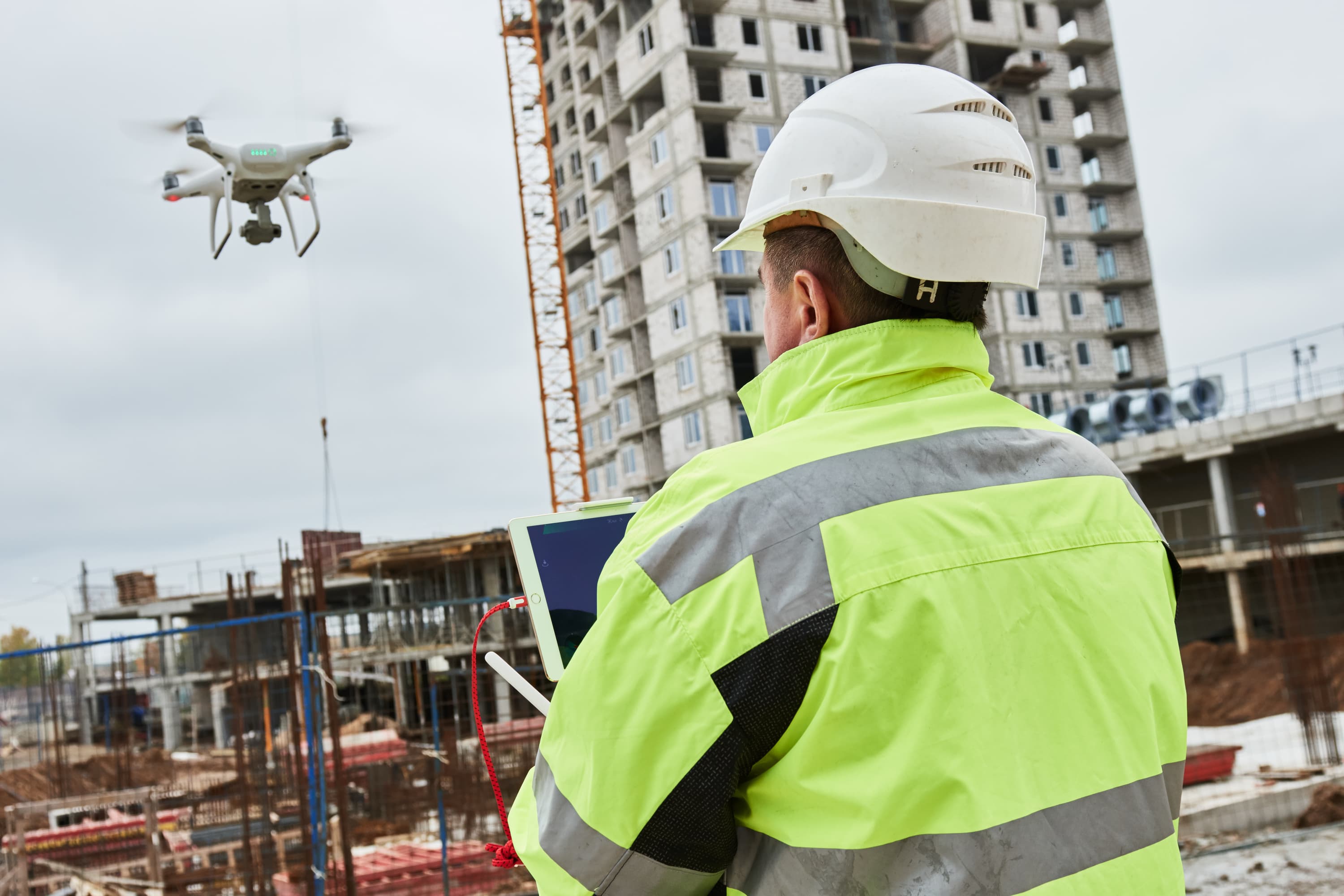 Construction worker operator drone on building site
