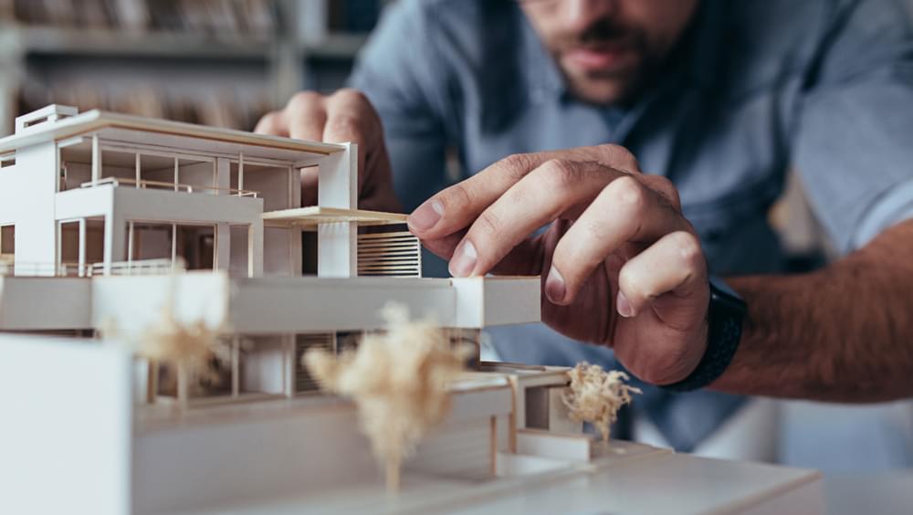 Man making wooden architectural model