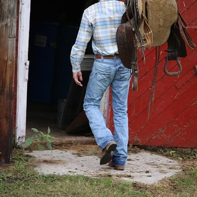 Cowboy going into barn
