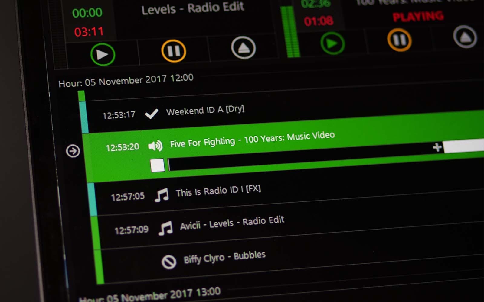 A close-up of the PlayIt Live interface and scheduled tracks.