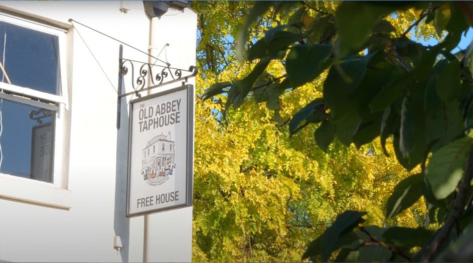 A close up of the The Old Abbey Taphouse sign, on the side of the pub.