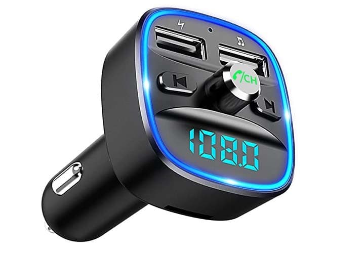 A black 12-volt to bluetooth adapter. The adapter is plug shaped, with an LED display, a dial, 2 USB ports and skip forward and skip backwards buttons.