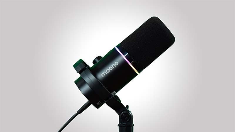 Image shows a black PD200X microphone, attached to a desk stand and point towards the top right corner.