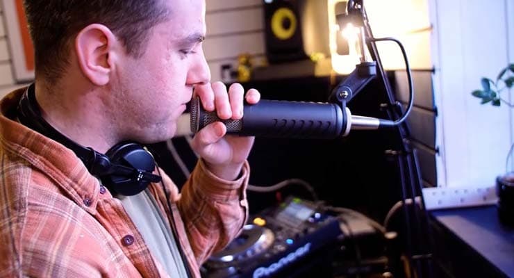 A male radio DJ speaking in a microphone.