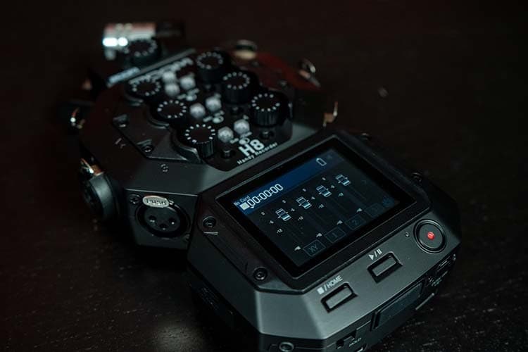 A close up of the Zoom H8 with the mixer function showing on the screen.