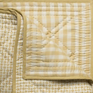 Cupid in faded yellow bedcover