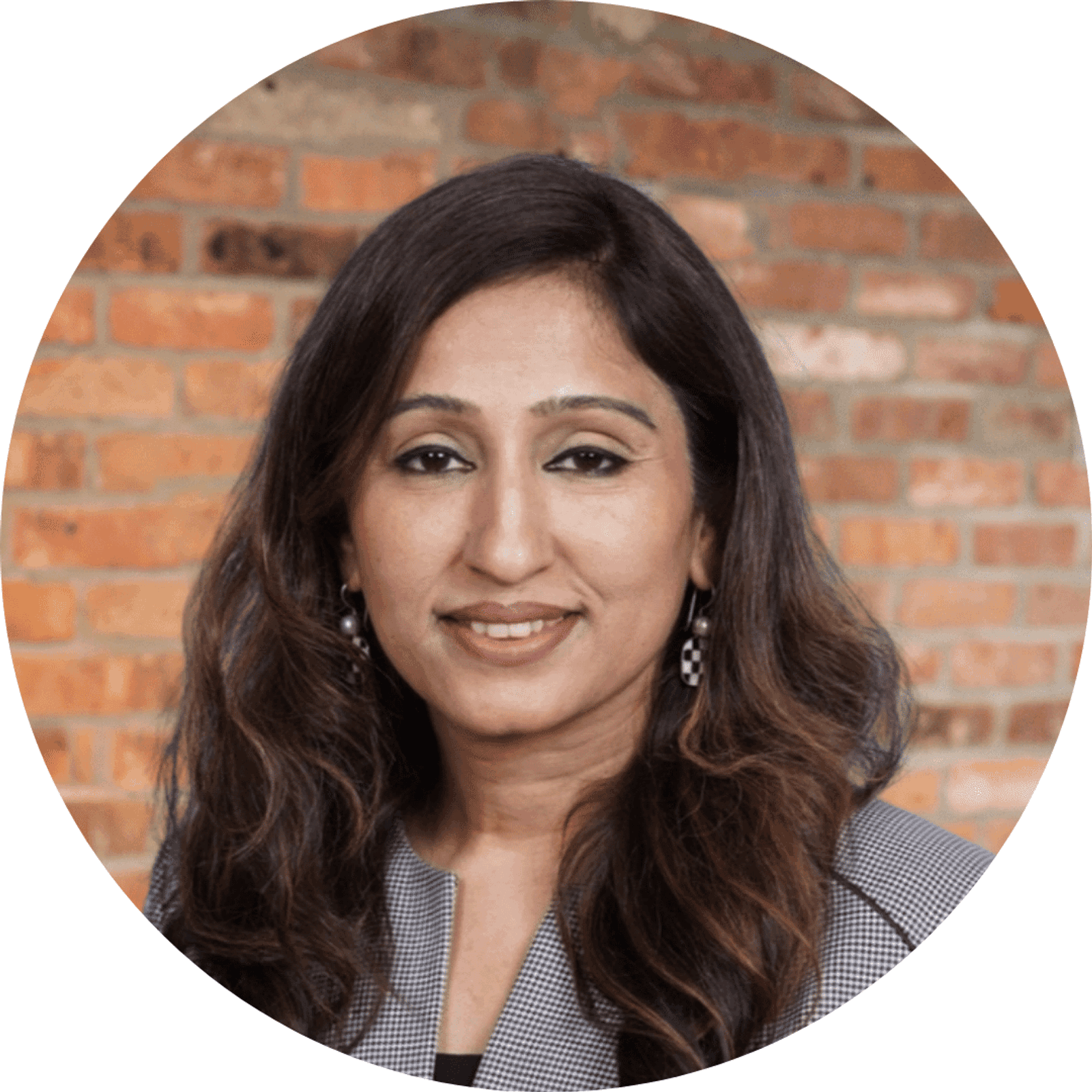 Nivedita Naithani's Headshot with a brick wall in the background