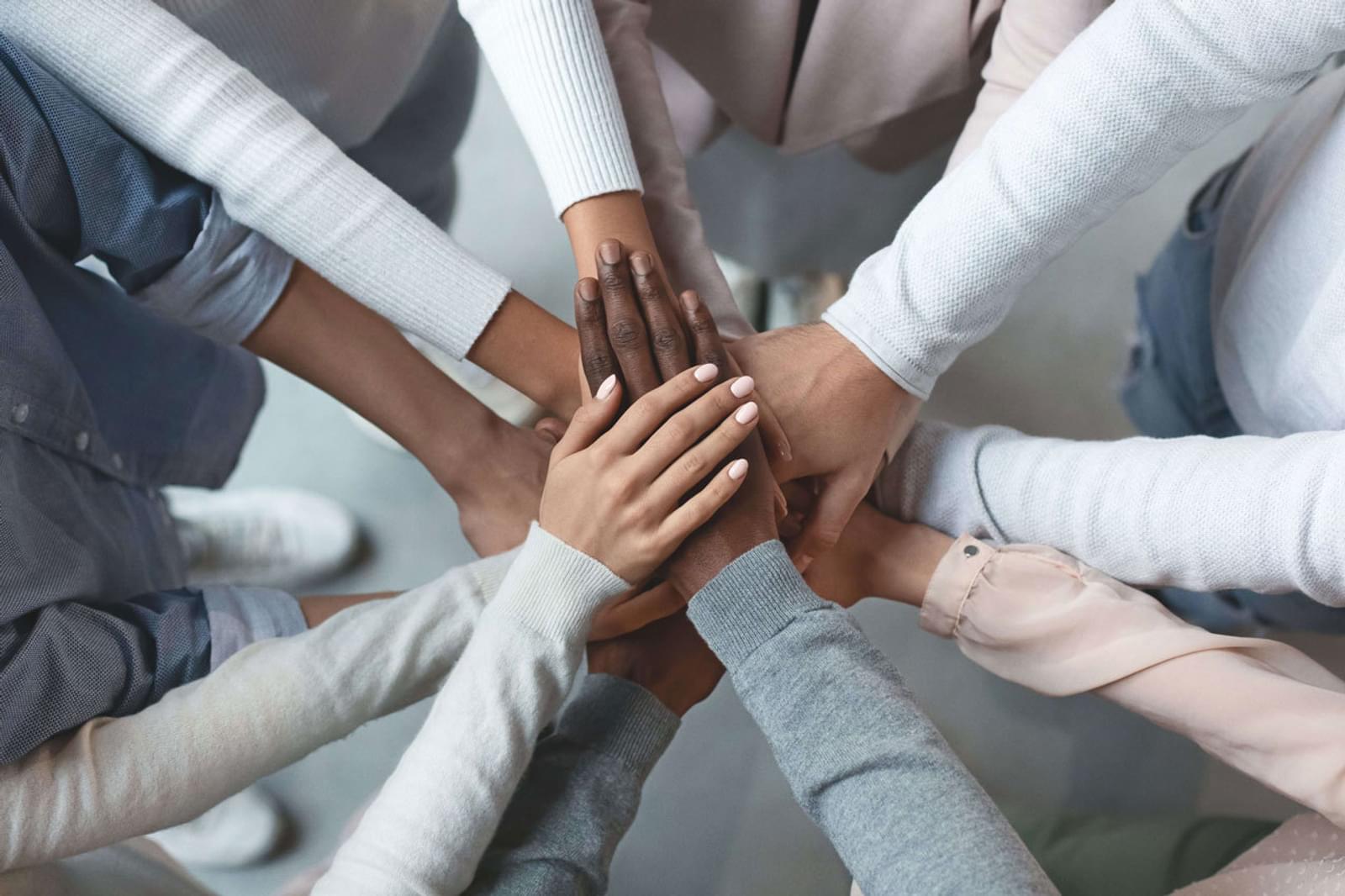 Business partners community team putting hands together on top of each other
