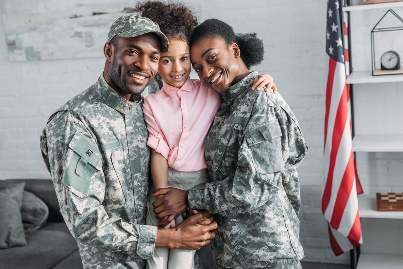 Military spouses family embracing daughter smiling hugging