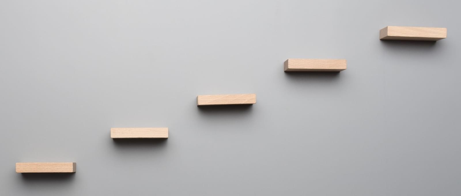 Wooden steps on a grey background banner image
