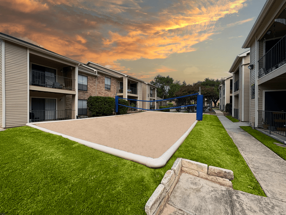 Village Green apartments stunning volleyball court with pool in background