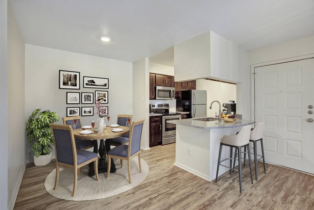 Village Green apartments Dining area with table and chairs next to kitchen