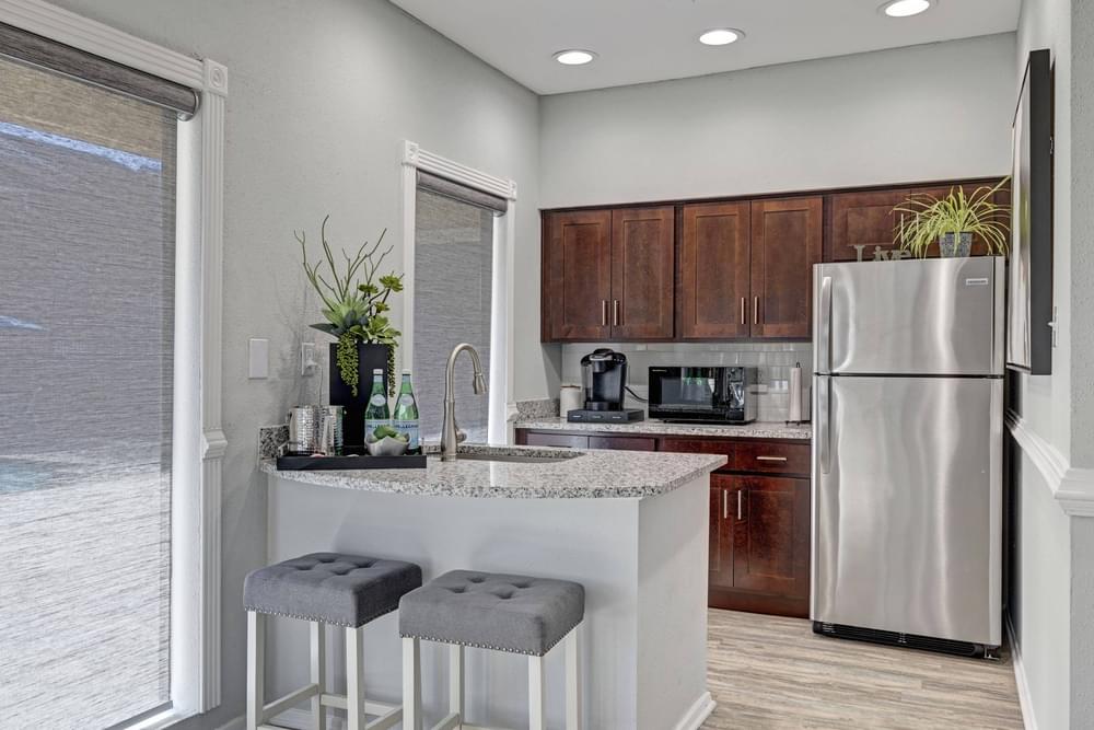 Village Green apartments Clubhouse kitchen with modern appliances and refreshment tray.