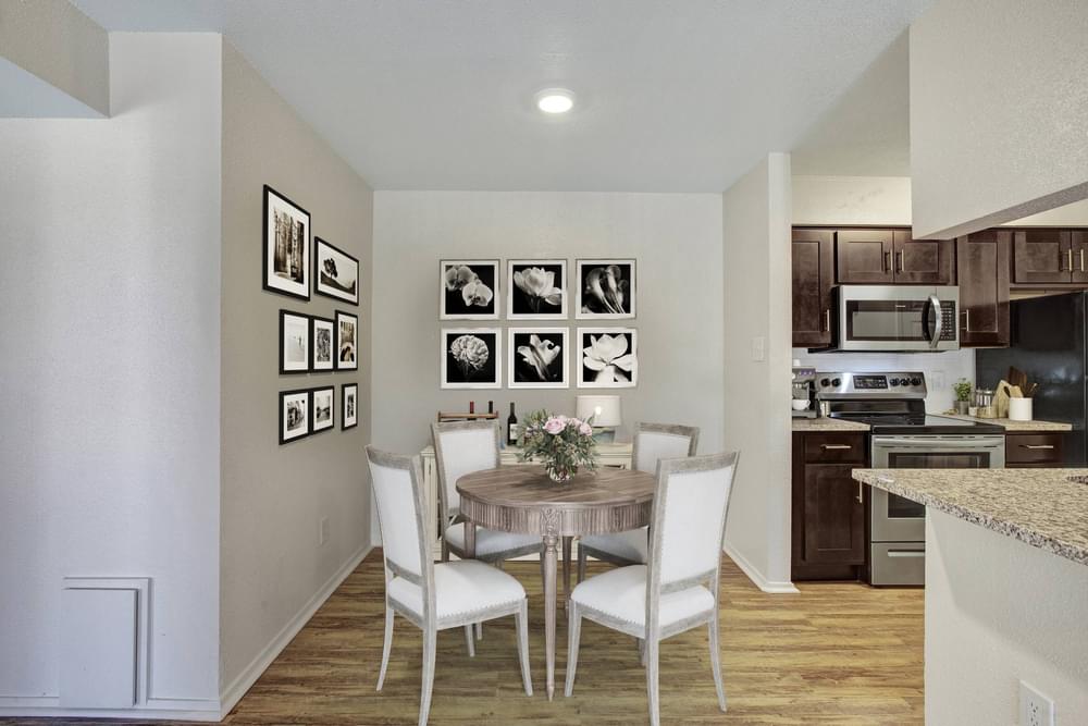 Village Green apartments Dining area with table and chairs next to kitchen