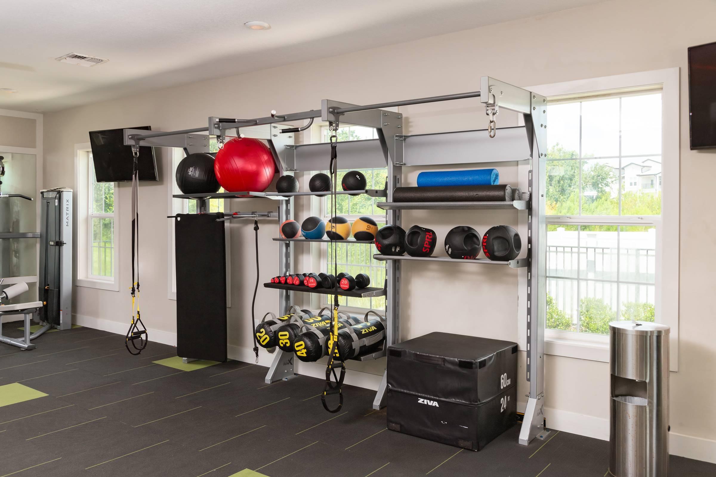 Shadetree Apartments fitness center with a room of fitness equipment, weights, and gym flooring