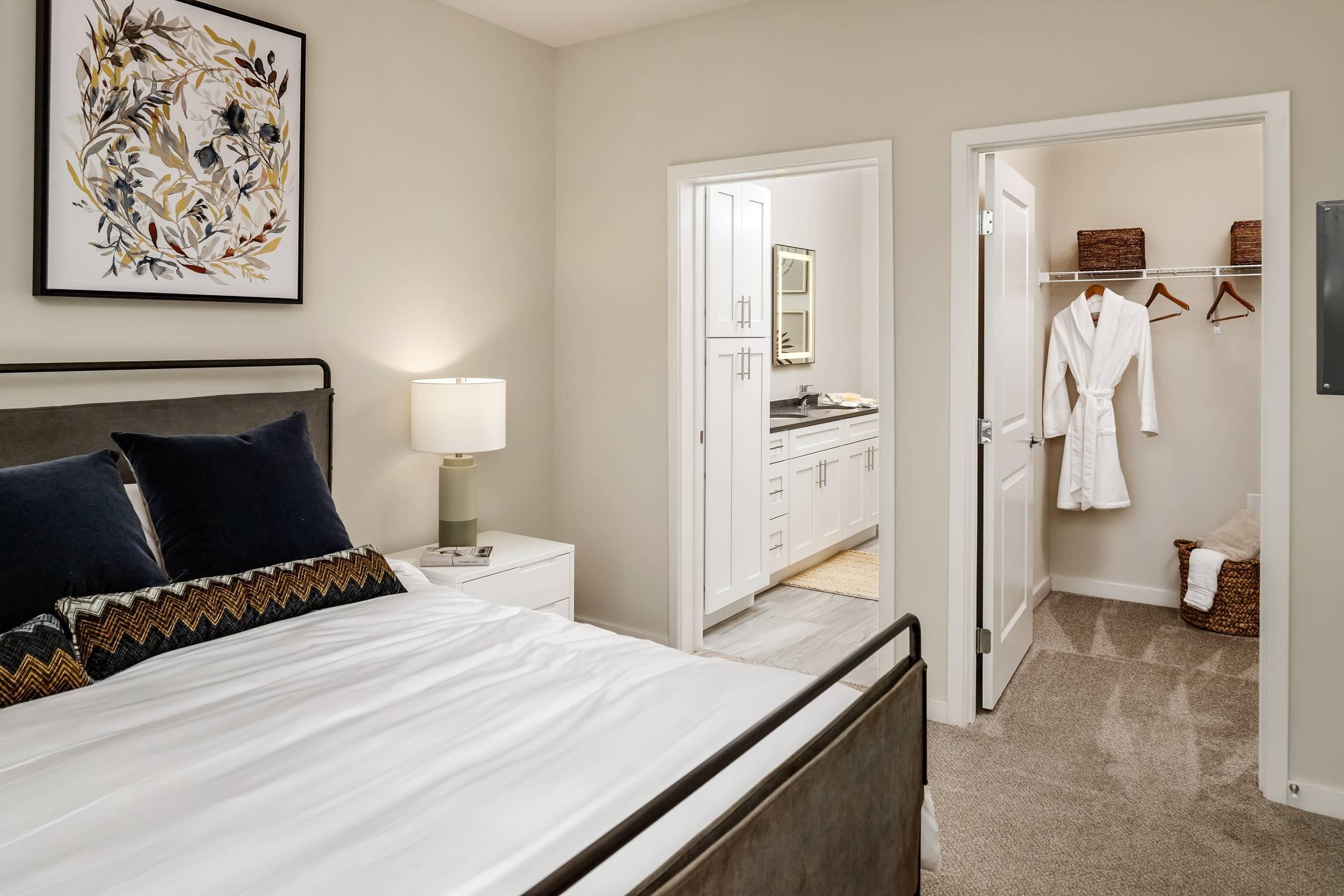 Shadetree Apartments bedroom with a large bed and a large walk-in closet